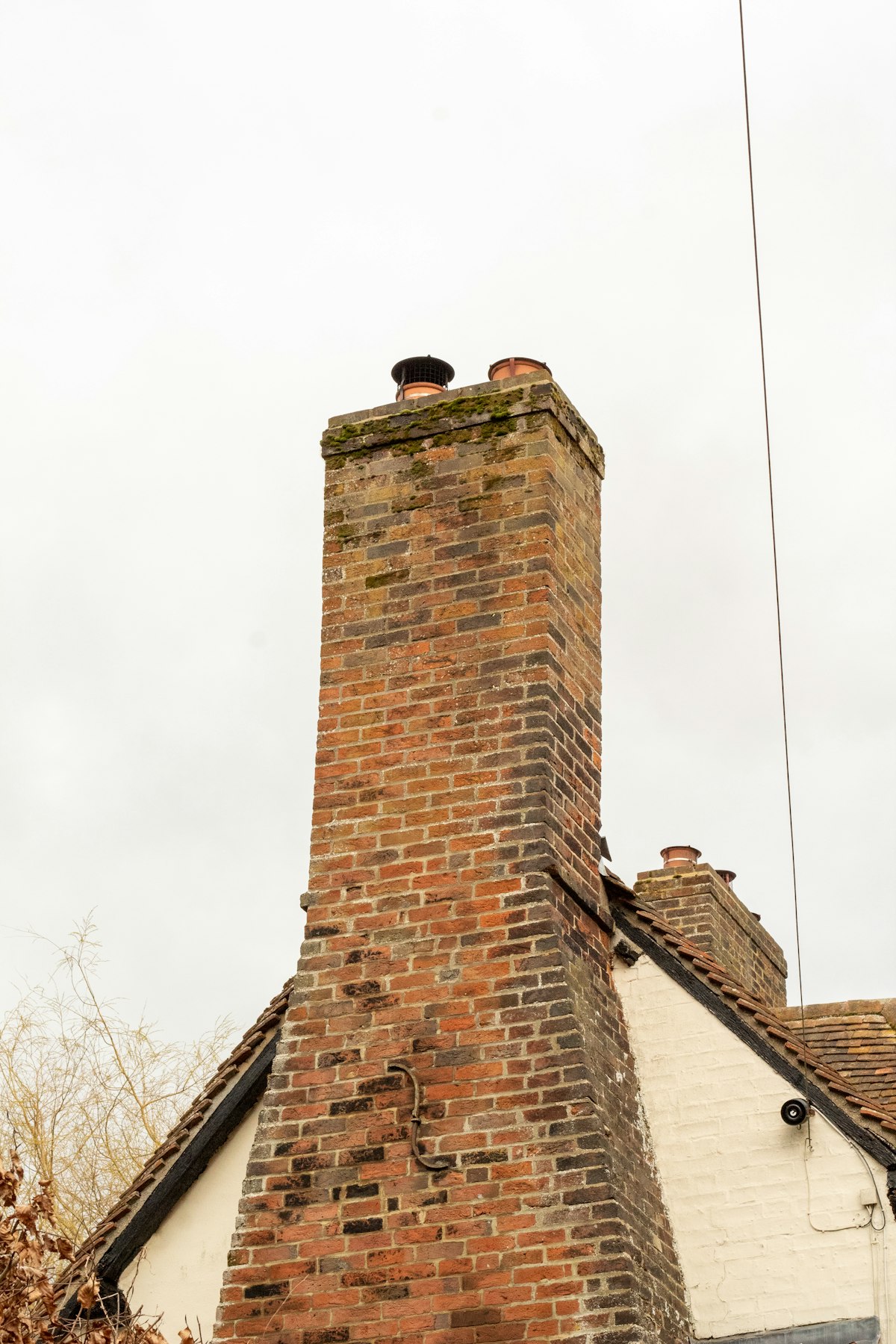 Tall red brick chimney on Canterbury home - 50 years trusted service